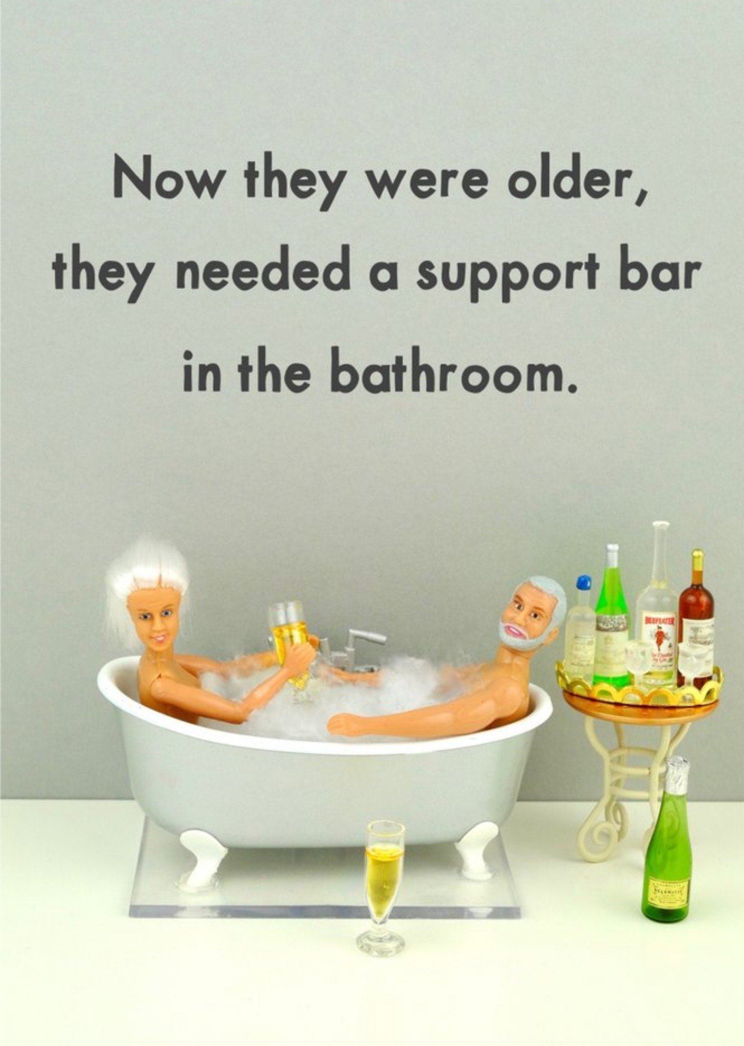 Bold And Bright Funny Photograph Of A Female And Male Doll Enjoying A Drink In A Bath Just To Say Card Ecard