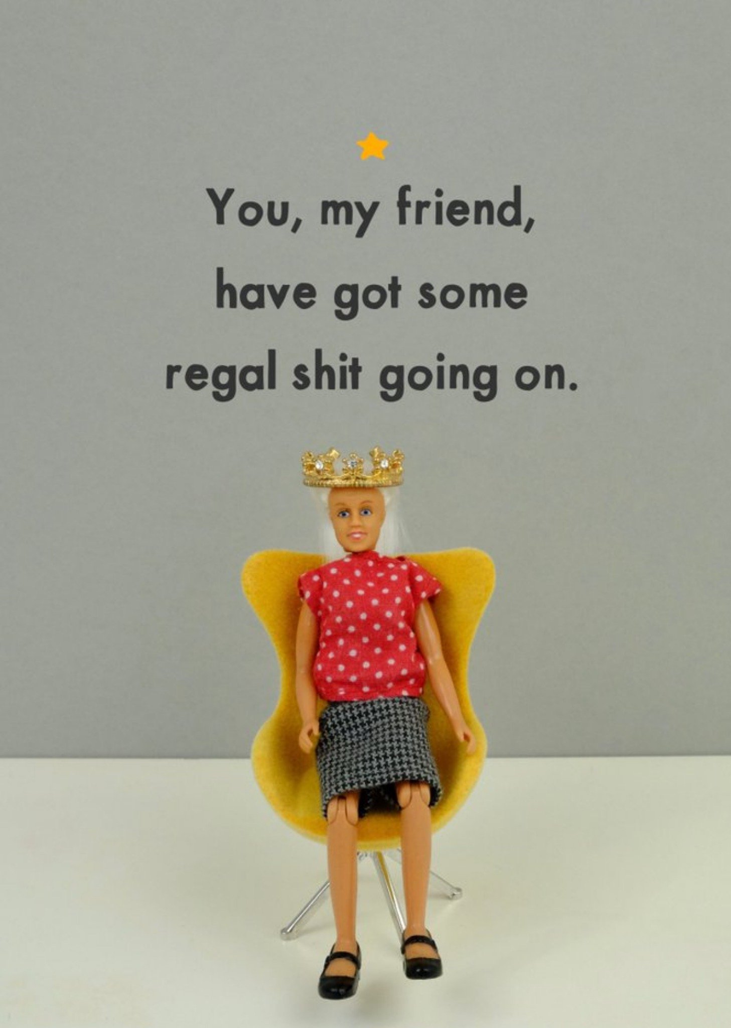 Bold And Bright Funny Photographic Image Of A Doll Sat In A Chair Wearing A Crown Regal Shit Going O